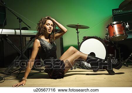 Stock Photograph - Female posing with musical equipment. Fotosearch
