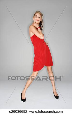 Full length portrait of pretty young blond woman in red dress View Large Photo Image Stock Image - Full length portrait of pretty young blond woman in red dress. Fotosearch