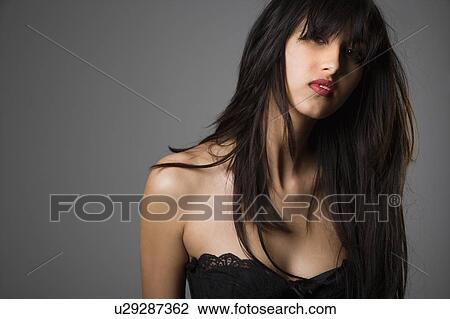 Head and shoulder portrait of pretty young woman with long black hair View Large Photo Image Stock Image - Head and shoulder portrait of pretty young woman with long black hair. Fotosearch