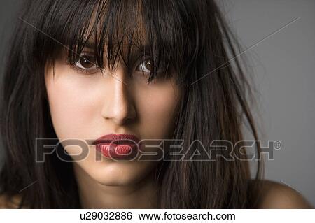 Stock Photograph - Headshot of pretty young woman with long black hair. Fotosearch