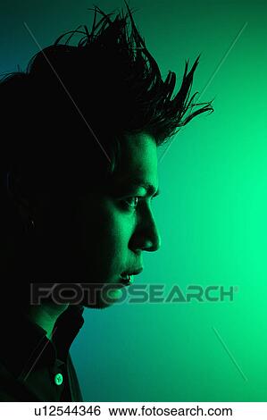 Stock Photograph - Side view of attractive young Asian man with spiked hair.. Fotosearch