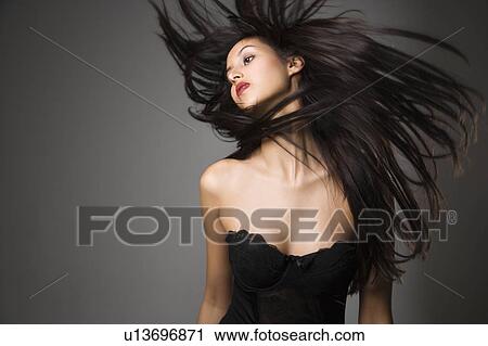 Woman flinging long black hair into air View Large Photo Image Stock Image - Woman flinging long black hair into air. Fotosearch