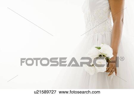 Stock Photo - African-American bride holding bouquet.. Fotosearch