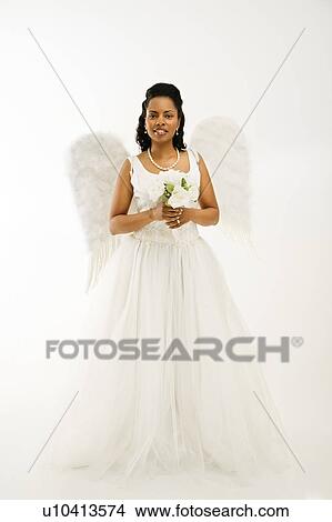 Angelic mid-adult African-American bride holding a bouquet on white background. View Large Photo Image Picture - Angelic mid-adult African-American bride holding a bouquet on white background.. Fotosearch