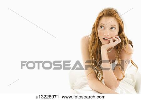Bride biting her finger and looking off to the side View Large Photo Image Stock Image - Bride biting her finger and looking off to the side . Fotosearch