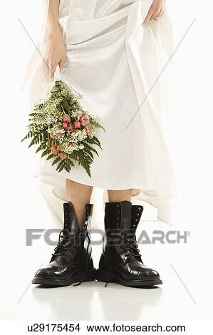 Bride holding bouquet down by her black combat boots View Large Photo Image Picture - Bride holding bouquet down by her black combat boots. Fotosearch