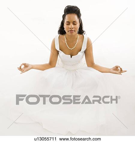 Stock Image - Bride mediating with white background. Fotosearch