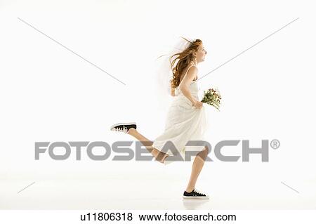 Stock Photo - Bride running and holding bouquet. Fotosearch
