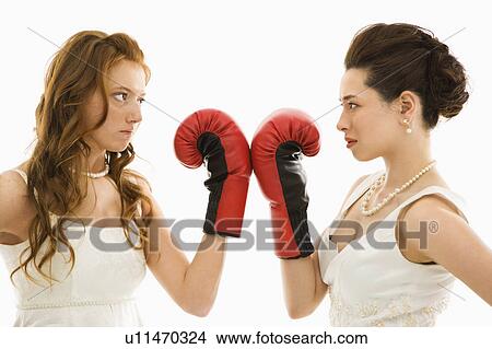 Picture - Brides holding boxing gloves up to each other. Fotosearch