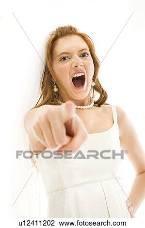 Stock Image - Caucasian bride screaming and pointing finger at viewer.. Fotosearch