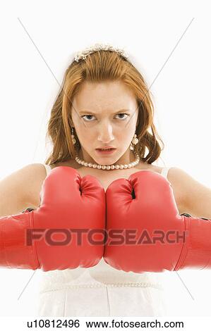 Stock Photograph - Caucasian bride with boxing gloves togther.. Fotosearch