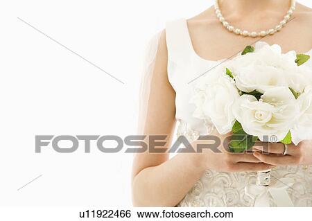Close up shot of bride holding bouquet View Large Photo Image Stock Photograph - Close up shot of bride holding bouquet. Fotosearch