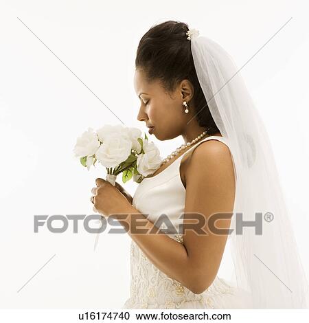 Stock Image - Mid-adult African-American bride on white background.. Fotosearch