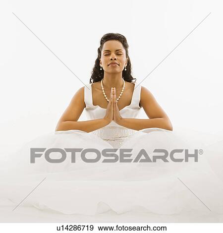 Mid-adult African-American bride praying with white background. View Large Photo Image Stock Photo - Mid-adult African-American bride praying with white background.. Fotosearch