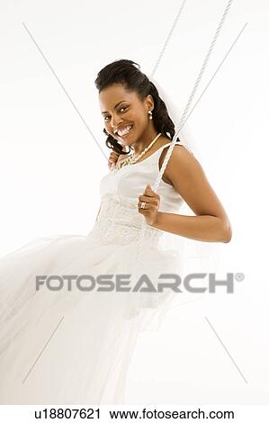 Mid-adult bride swinging with white background View Large Photo Image Stock Image - Mid-adult bride swinging with white background. Fotosearch