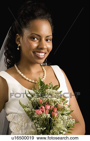 Stock Photo - Portrait of a bride on black background. Fotosearch