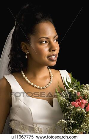 Stock Photography - Portrait of a bride on black background. Fotosearch
