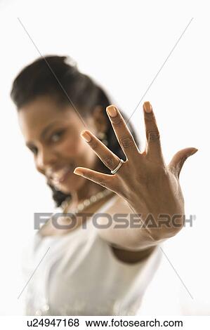 Portrait of a mid-adult bride showing ring to viewer View Large Photo Image Stock Photo - Portrait of a mid-adult bride showing ring to viewer. Fotosearch