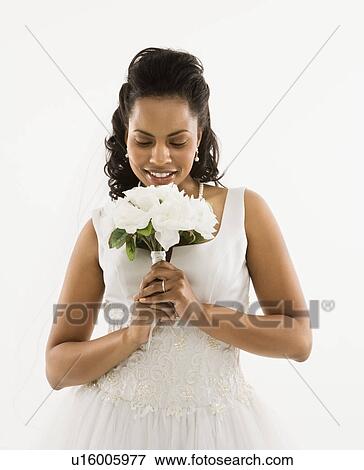 Portrait of a mid-adult African-American bride holding bouquet. View Large Photo Image Stock Photo - Portrait of a mid-adult African-American bride holding bouquet.. Fotosearch