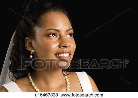 Portrait of a mid-adult African-American bride on black background. View Large Photo Image Stock Photo - Portrait of a mid-adult African-American bride on black background.. Fotosearch