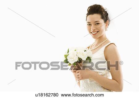 Stock Image - Portrait of Asian bride with bouquet.. Fotosearch