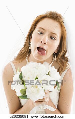 Portrait of Caucasian bride holding bouquet and making funny face. View Large Photo Image Stock Image - Portrait of Caucasian bride holding bouquet and making funny face.. Fotosearch