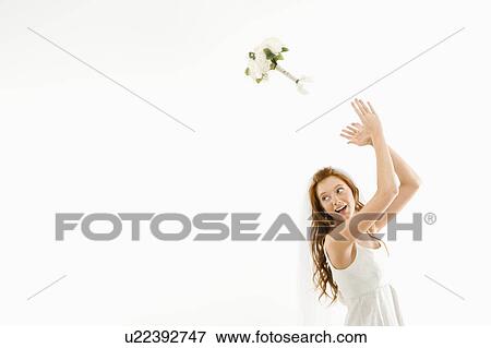 Portrait of Caucasian bride tossing bouquet behind her. View Large Photo Image Stock Photo - Portrait of Caucasian bride tossing bouquet behind her.. Fotosearch