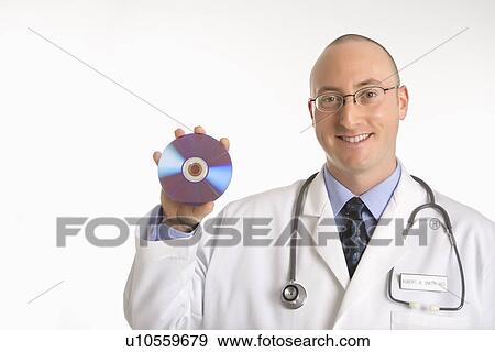 Caucasian mid adult male physician holding compact disc. View Large Photo Image Stock Photo - Caucasian mid adult male physician holding compact disc.. Fotosearch