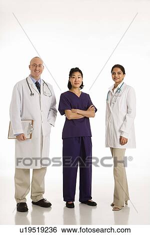 Caucasian mid adult male physician with Asian and Indian women doctors. View Large Photo Image Stock Photograph - Caucasian mid adult male physician with Asian and Indian women doctors.. Fotosearch