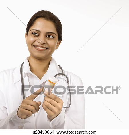 Indian woman doctor explaining medication. View Large Photo Image Stock Image - Indian woman doctor explaining medication.. Fotosearch