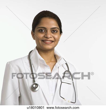 Stock Image - Indian woman doctor head and shoulder portrait on white background.. Fotosearch