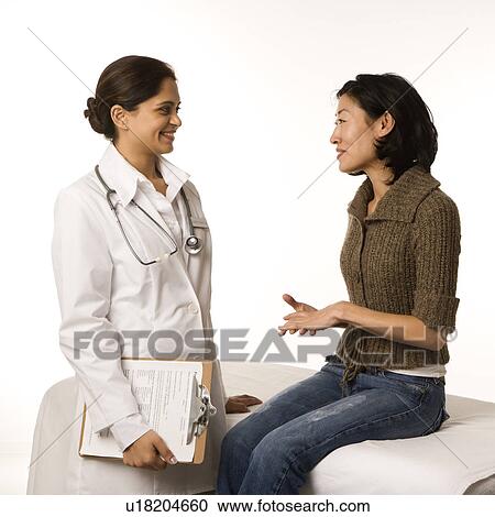 Indian woman doctor with Asian woman patient. View Large Photo Image Stock Image - Indian woman doctor with Asian woman patient.. Fotosearch