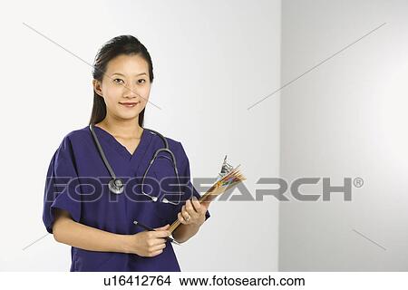 Picture - Portrait of Asian Chinese mid-adult female doctor smiling and looking at viewer.. Fotosearch