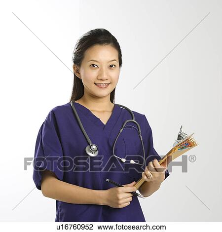 Stock Image - Portrait of Asian Chinese mid-adult female doctor smiling and looking at viewer.. Fotosearch