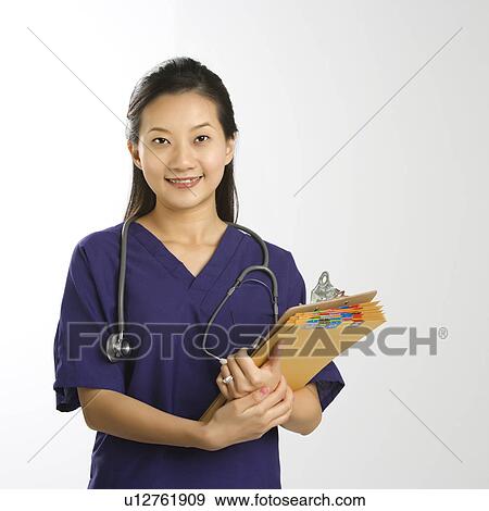 Stock Photo - Portrait of Asian Chinese mid-adult female doctor smiling and looking at viewer.. Fotosearch