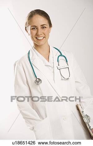 Stock Photograph - Portrait of Caucasian mid-adult female doctor smiling and looking at viewer.. Fotosearch