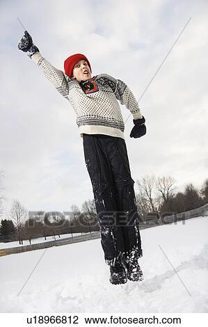 Stock Image - Boy wearing sweater and red winter cap . Fotosearch