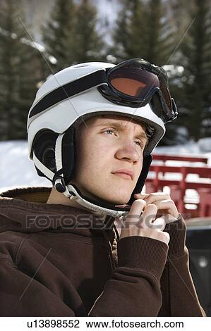 Caucasian male teenager fastening helmet. View Large Photo Image Stock Image - Caucasian male teenager fastening helmet.. Fotosearch