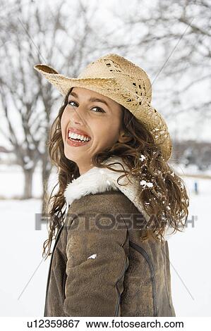 Female outdoors in snow smiling at viewer wearing straw cowboy hat View Large Photo Image Stock Photo - Female outdoors in snow smiling at viewer wearing straw cowboy hat. Fotosearch
