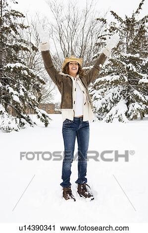 Female standing and playing in the snow wearing straw cowboy hat View Large Photo Image Stock Image - Female standing and playing in the snow wearing straw cowboy hat. Fotosearch