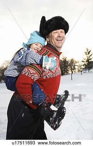 Middle aged man holding little girl piggyback style smiling and looking at viewer View Large Photo Image Stock Image - Middle aged man holding little girl piggyback style smiling and looking at viewer. Fotosearch