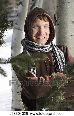 Portrait of a male teenager wearing hoodie and scarf in winter setting View Large Photo Image Stock Photograph - Portrait of a male teenager wearing hoodie and scarf in winter setting. Fotosearch