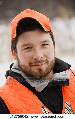Portrait of young mid-adult male wearing blaze orange safety hunting clothing. View Large Photo Image Stock Image - Portrait of young mid-adult male wearing blaze orange safety hunting clothing.. Fotosearch