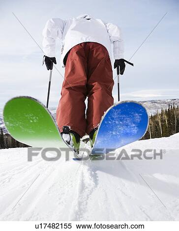 Rear view of mid-adult male on skis in Steamboat, Colorado View Large Photo Image Stock Photography - Rear view of mid-adult male on skis in Steamboat, Colorado. Fotosearch