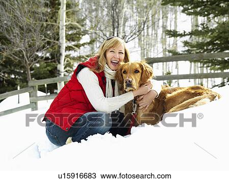 Woman hugging dog and smiling in snow covered Colorado landscape. View Large Photo Image Stock Image - Woman hugging dog and smiling in snow covered Colorado landscape.. Fotosearch