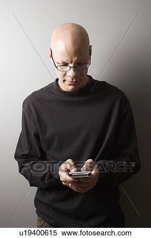 Stock Photography - Male holding PDA. Fotosearch