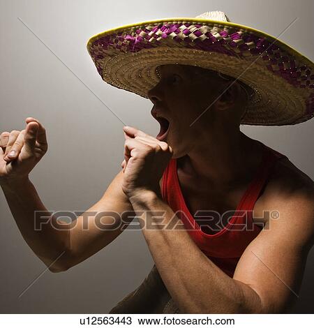 Stock Image - Male wearing sombrero snapping fingers. Fotosearch