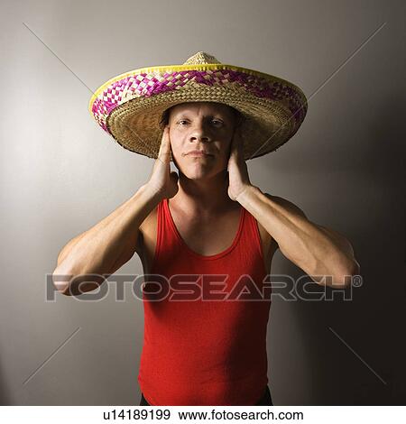 Male wearing sombrero with hands over ears View Large Photo Image Stock Photo - Male wearing sombrero with hands over ears. Fotosearch