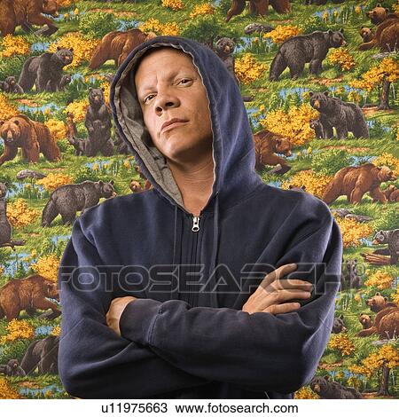 Stock Image - Portrait of a Mid-adult Caucasian male wearing a hoodie.. Fotosearch