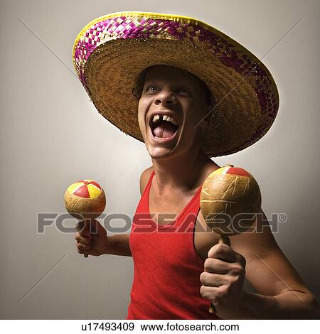 Portrait of a Mid-adult Caucasian male wearing sombrero holding maracas. View Large Photo Image Stock Photo - Portrait of a Mid-adult Caucasian male wearing sombrero holding maracas.. Fotosearch